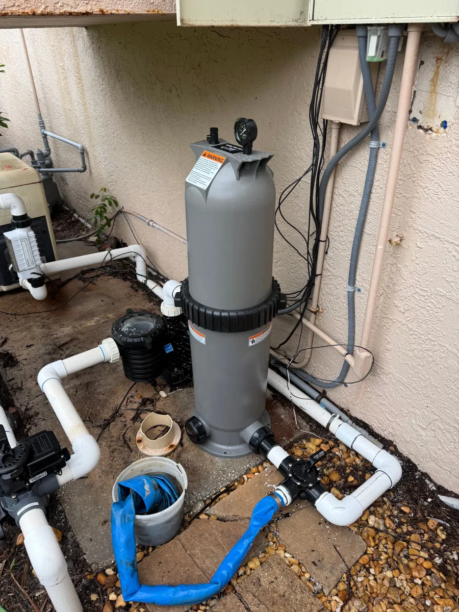 Cartridge filter and pump with new PVC plumbing at a pool equipment pad