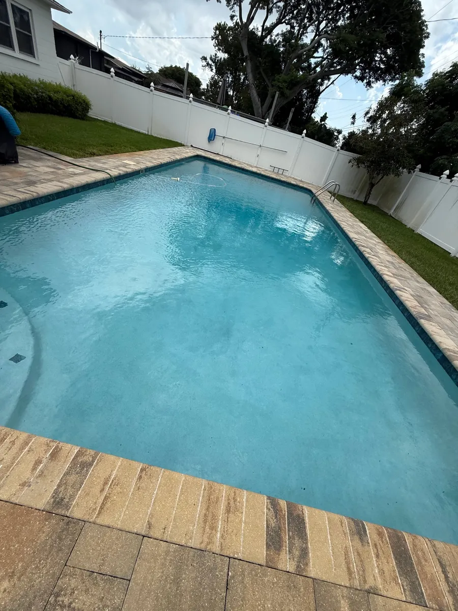 Rectangular backyard pool after weekly cleaning